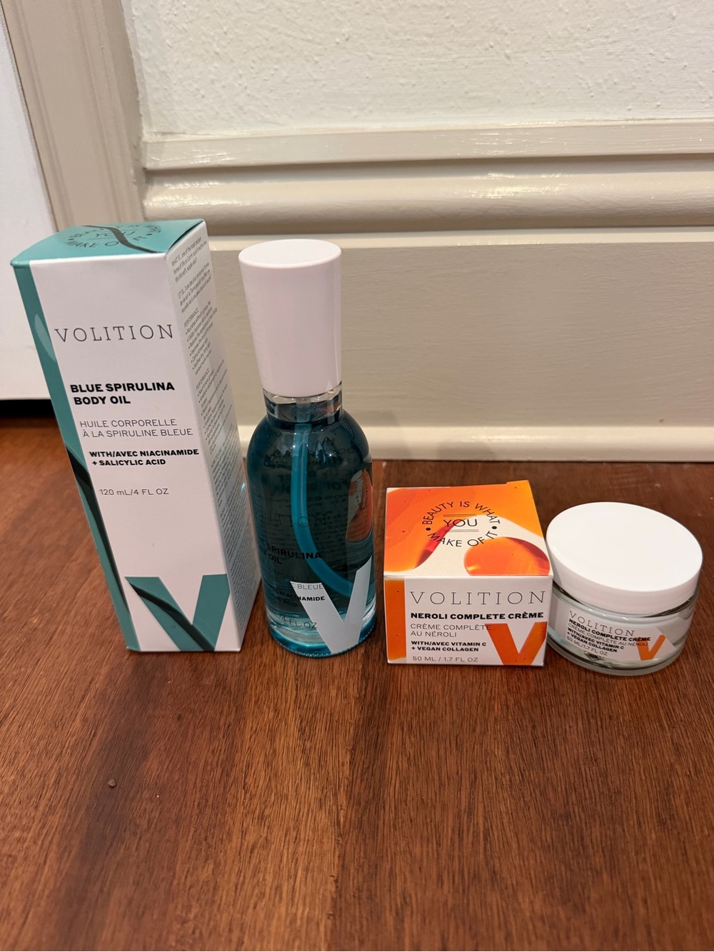 Blue Spirulina Body Oil in Teal and Neroli Complete Crème in Orange